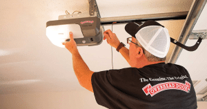 Man adjusting garage door opener.