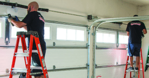Two men installing a garage door.